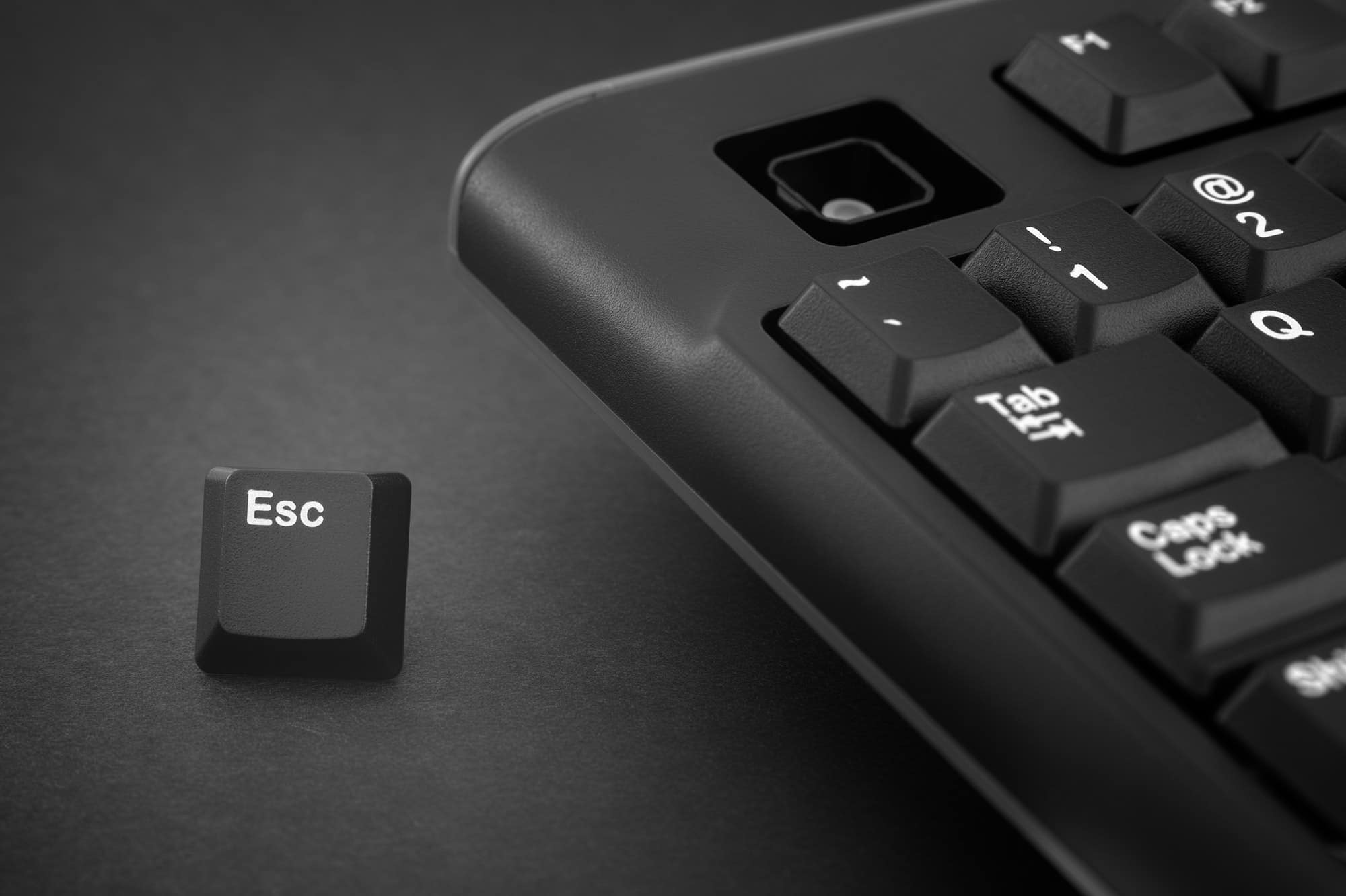 Escape key escapes from a black computer keyboard | The Swiss Quality