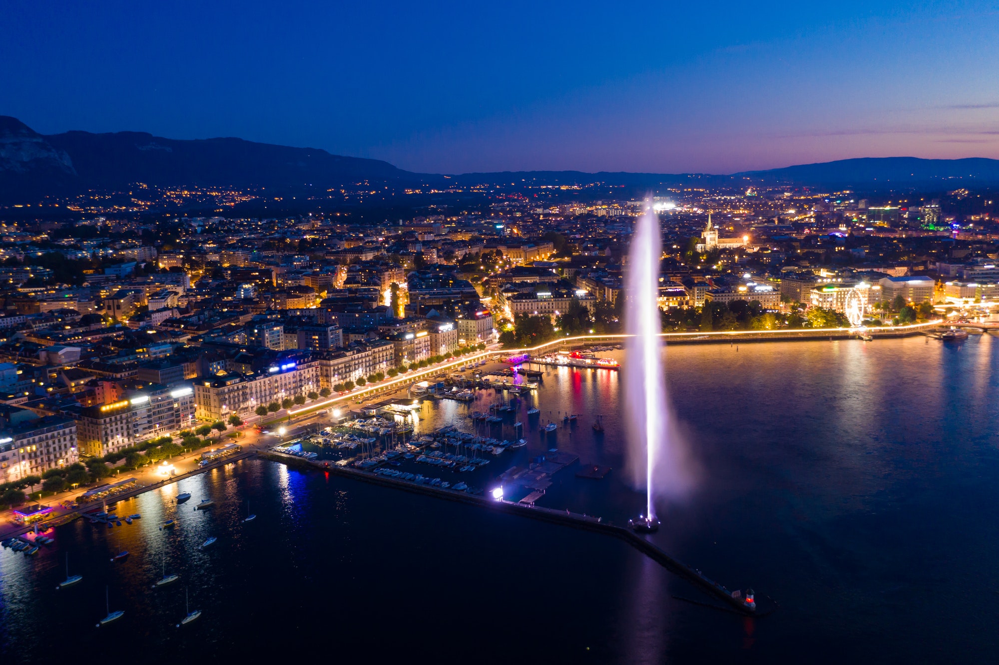 Aerial night view of Geneva city water fountain in Switzerland | The