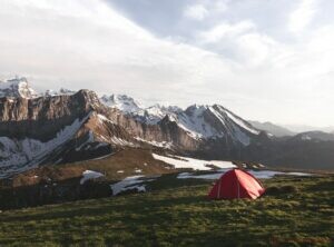 tent in front of a mountain ridge in switzerland
