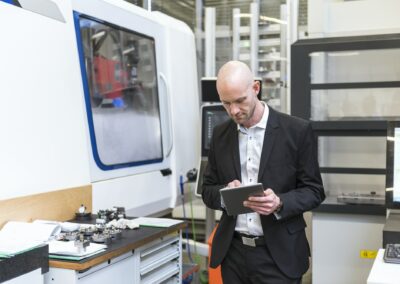 businessman using tablet in modern factory - Strategic Reading