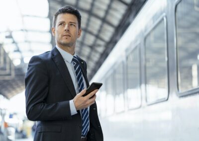Change Management - businessman with cell phone on station platform