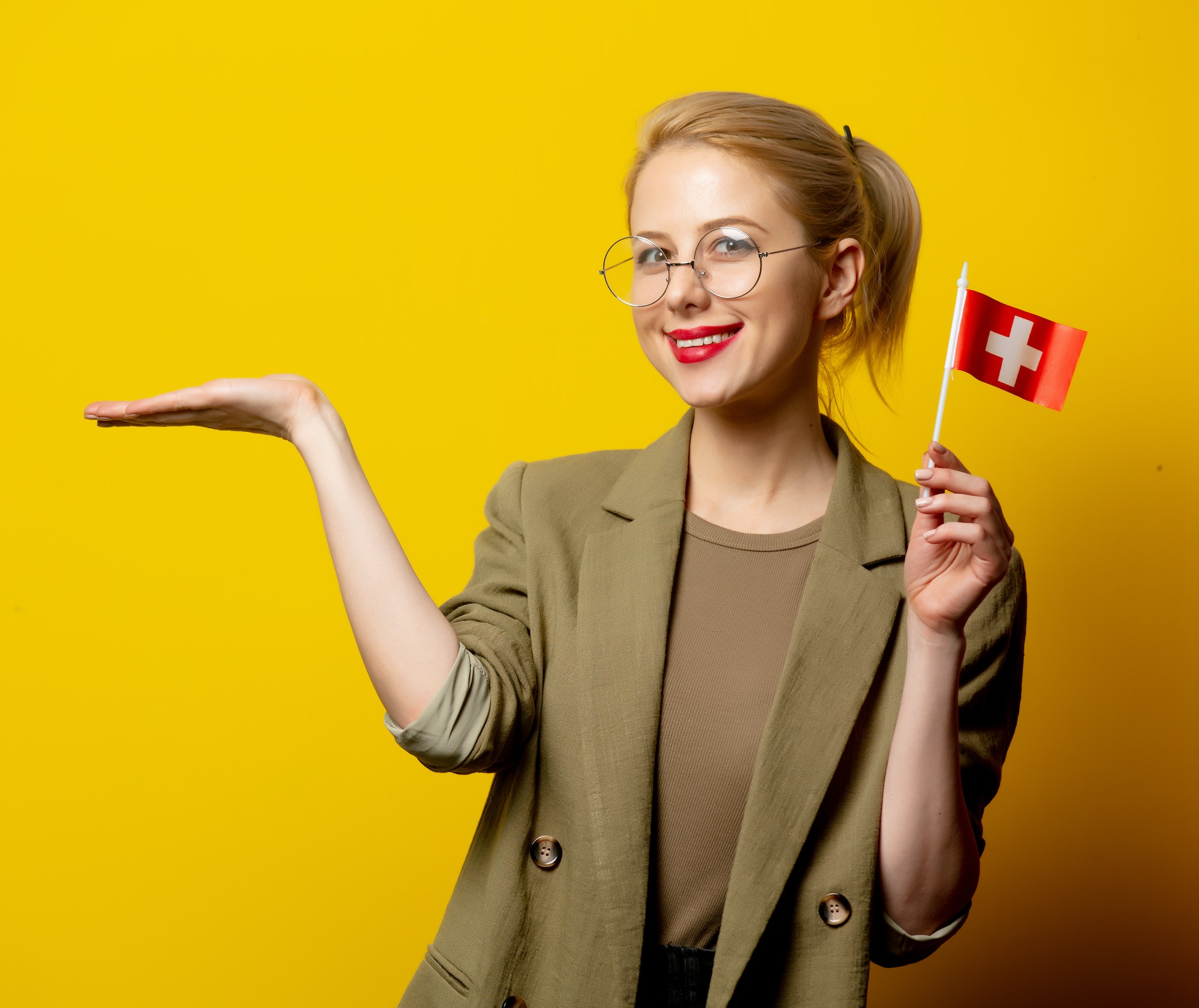 style blonde woman in jacket with swiss flag on yellow background 3