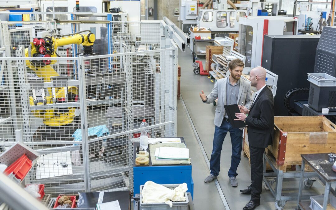 two businessmen discussing in modern factory